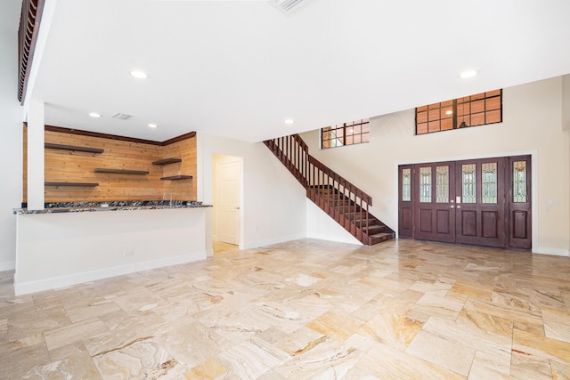 foyer entrance featuring wooden walls