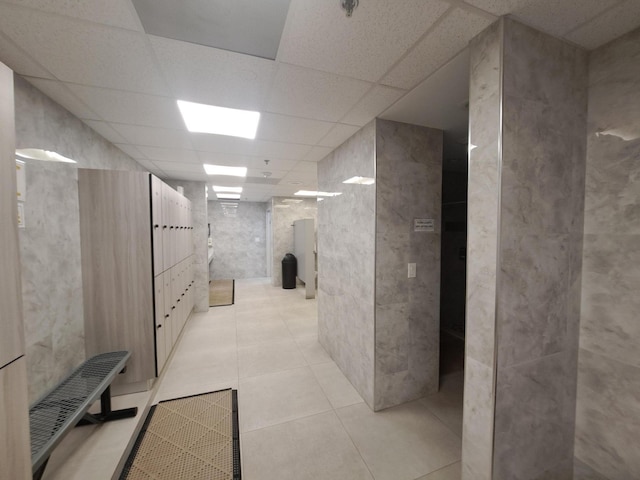 bathroom featuring tile patterned floors and a drop ceiling