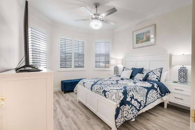 bedroom featuring ceiling fan, light hardwood / wood-style floors, and ornamental molding