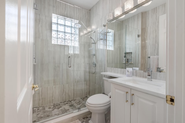 bathroom with vanity, toilet, and walk in shower