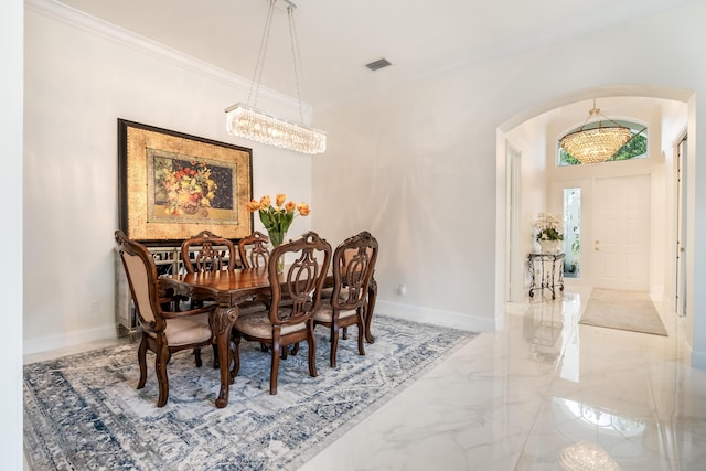 dining space with a notable chandelier and ornamental molding