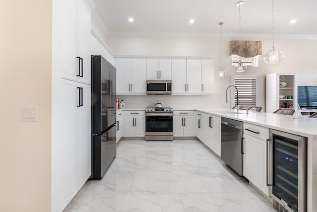 kitchen with kitchen peninsula, stainless steel appliances, beverage cooler, pendant lighting, and white cabinets