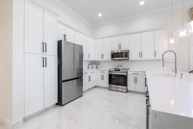 kitchen with sink, crown molding, decorative light fixtures, white cabinets, and appliances with stainless steel finishes