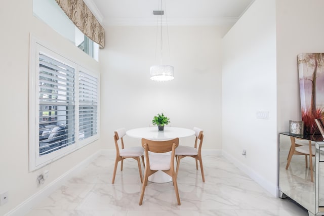 dining space with crown molding