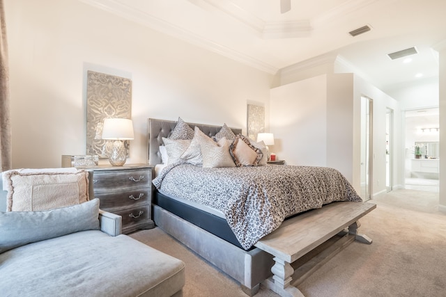 carpeted bedroom featuring ensuite bathroom, ceiling fan, ornamental molding, and a tray ceiling