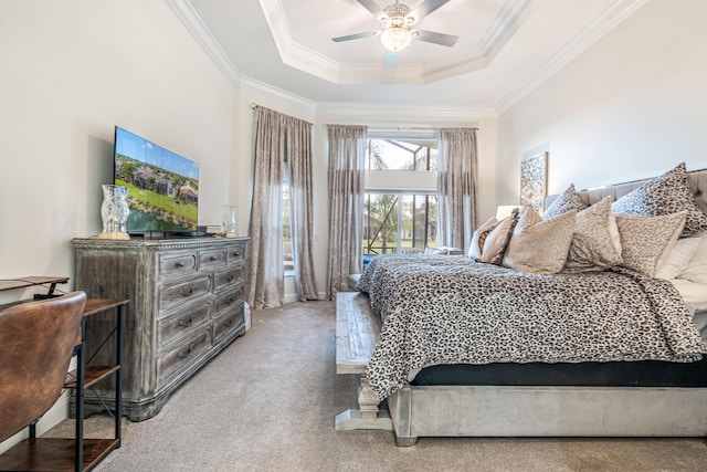 carpeted bedroom featuring ceiling fan, a raised ceiling, and crown molding