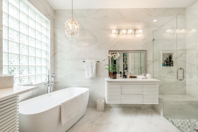 bathroom with vanity, separate shower and tub, tile walls, and an inviting chandelier