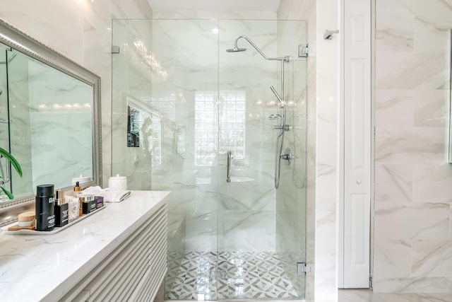 bathroom featuring vanity and a shower with shower door