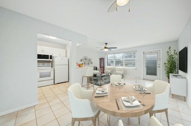 tiled dining room featuring ceiling fan