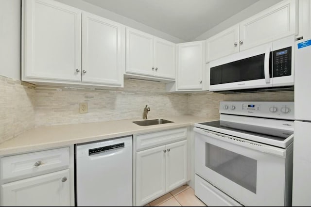 kitchen featuring white cabinetry, sink, and white appliances