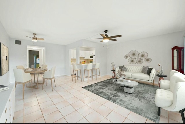 living room with ceiling fan and light tile patterned flooring