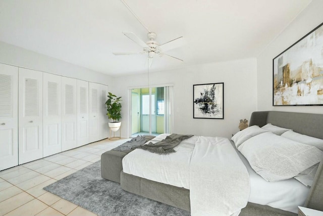 bedroom with light tile patterned floors, connected bathroom, a closet, and ceiling fan