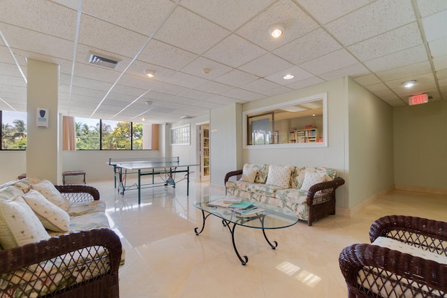 tiled living room featuring a drop ceiling