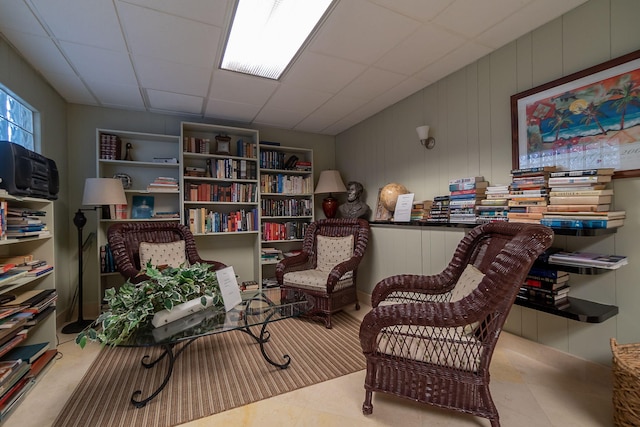 sitting room featuring a drop ceiling