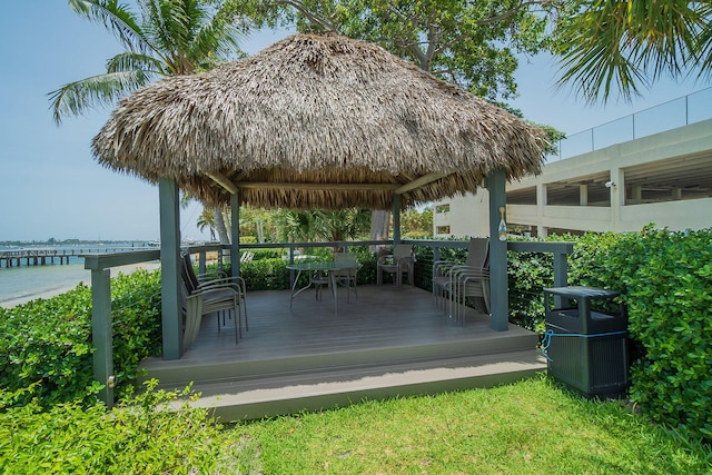 wooden terrace featuring a water view and a gazebo