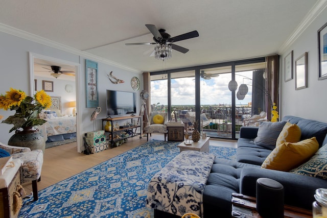 living room featuring hardwood / wood-style flooring, a textured ceiling, expansive windows, and ornamental molding