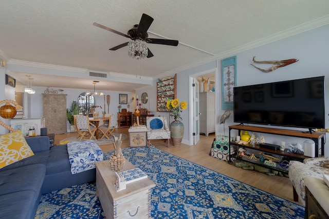 living room featuring a textured ceiling, crown molding, and wood-type flooring