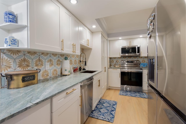 kitchen featuring light stone countertops, white cabinets, and appliances with stainless steel finishes