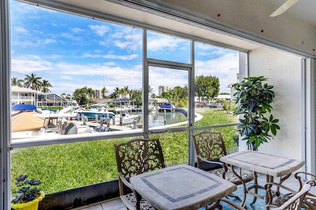 sunroom / solarium with a water view