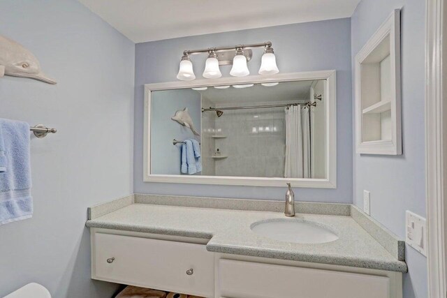 bathroom with vanity and curtained shower