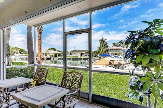 sunroom / solarium with a water view