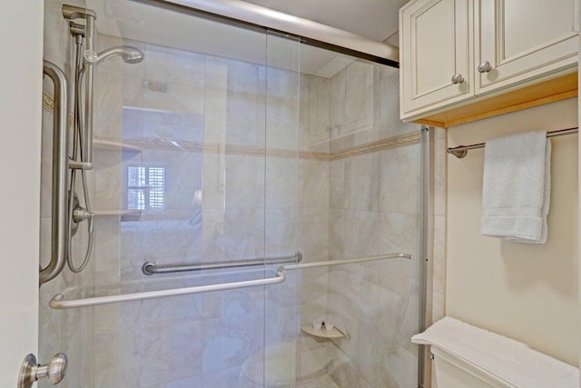 bathroom featuring an enclosed shower and toilet