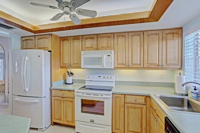 kitchen featuring white appliances, a raised ceiling, ceiling fan, and sink