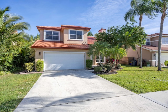 mediterranean / spanish-style house featuring a front yard and a garage