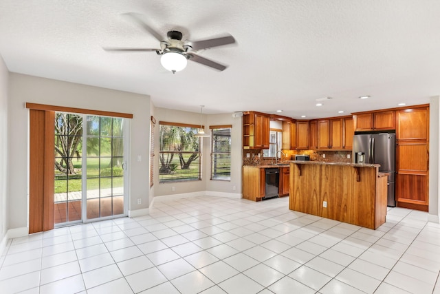 kitchen featuring a center island, black dishwasher, tasteful backsplash, light tile patterned flooring, and stainless steel fridge with ice dispenser