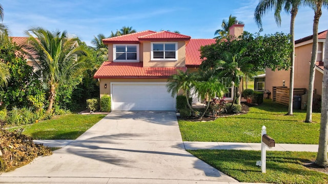 mediterranean / spanish house featuring a garage and a front yard