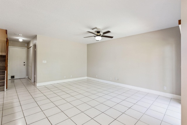 tiled spare room featuring ceiling fan and a textured ceiling