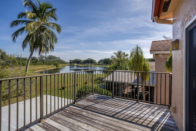 wooden deck featuring a water view