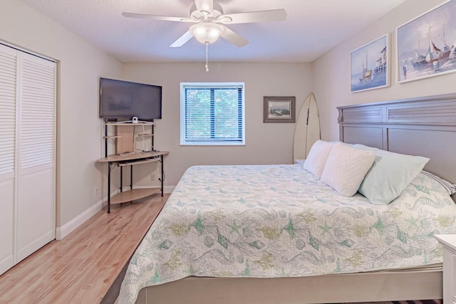 bedroom featuring light hardwood / wood-style flooring, a closet, and ceiling fan