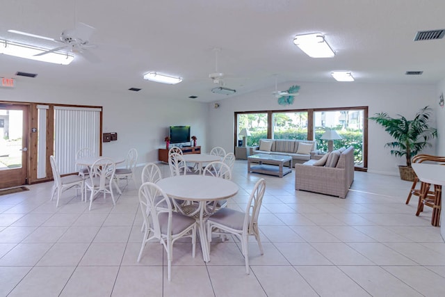 tiled dining room featuring ceiling fan and lofted ceiling