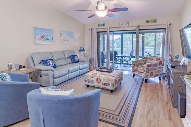 living room with ceiling fan, lofted ceiling, and light wood-type flooring