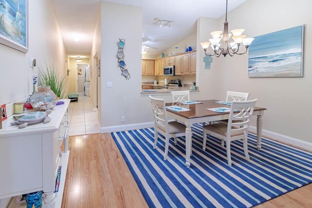 kitchen featuring ceiling fan, light brown cabinets, stainless steel range oven, and light hardwood / wood-style flooring