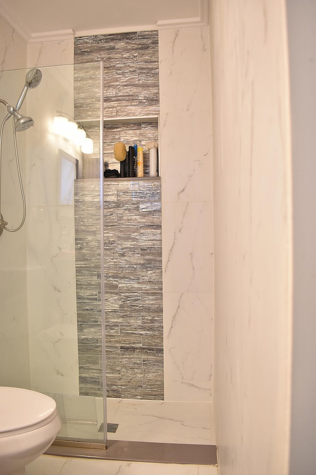 bathroom with tiled shower, tile walls, and toilet