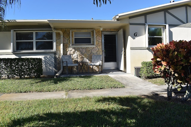 property entrance with a yard