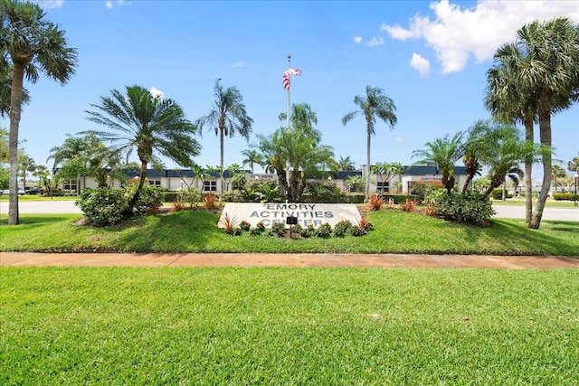 community sign featuring a lawn