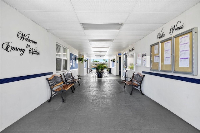 hallway featuring a paneled ceiling