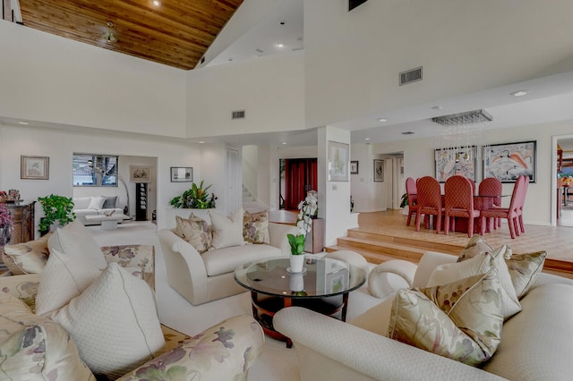 living room featuring high vaulted ceiling and wooden ceiling