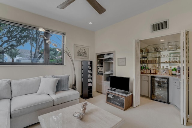 carpeted living room featuring bar and beverage cooler