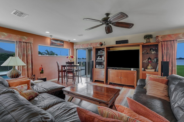 living room with hardwood / wood-style flooring and ceiling fan