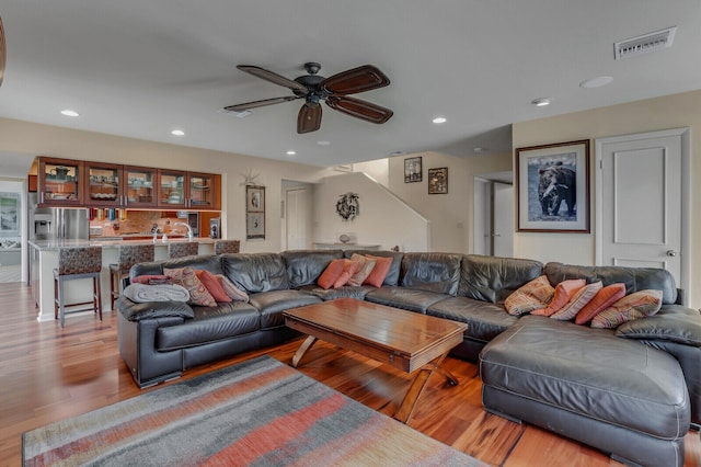 living room with ceiling fan and light hardwood / wood-style floors