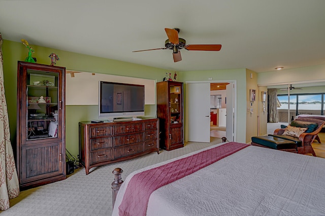 bedroom featuring ceiling fan and light carpet