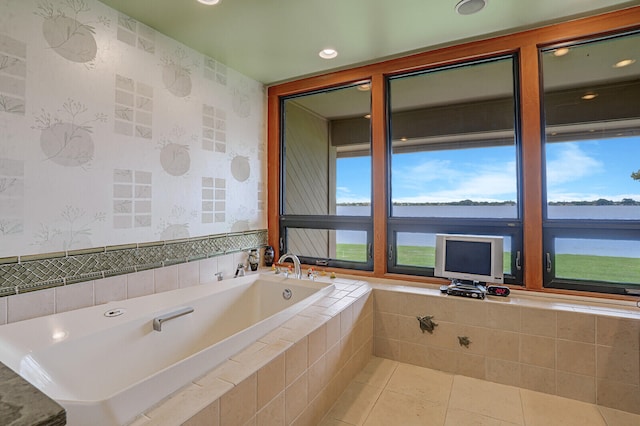 bathroom featuring tile patterned floors and a relaxing tiled tub