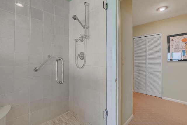 bathroom with a shower with door