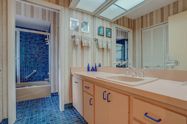 bathroom with shower / bath combination with glass door, tile patterned floors, and vanity