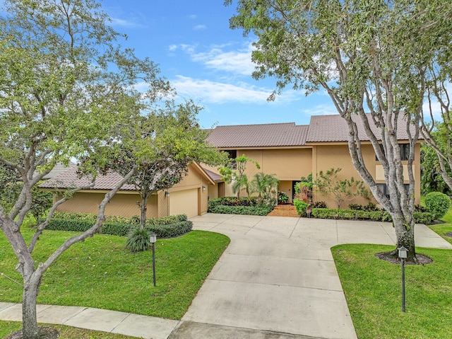 view of front facade featuring a garage and a front lawn