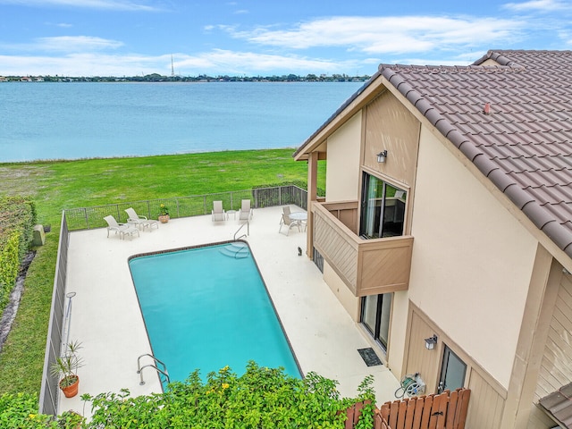 view of pool featuring a water view and a patio